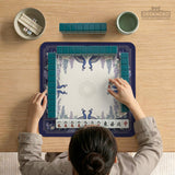 Blue mahjong mat with a floral peacock border and an open center area for tile play.