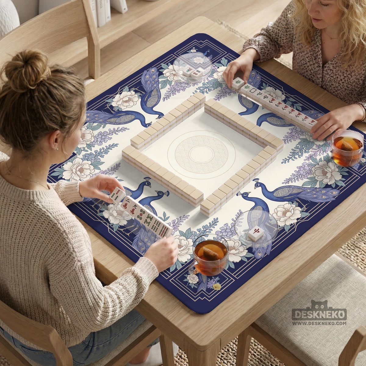 Blue mahjong table mat with a peacock and floral border, ivory center, lavender flowers, and scalloped edges.