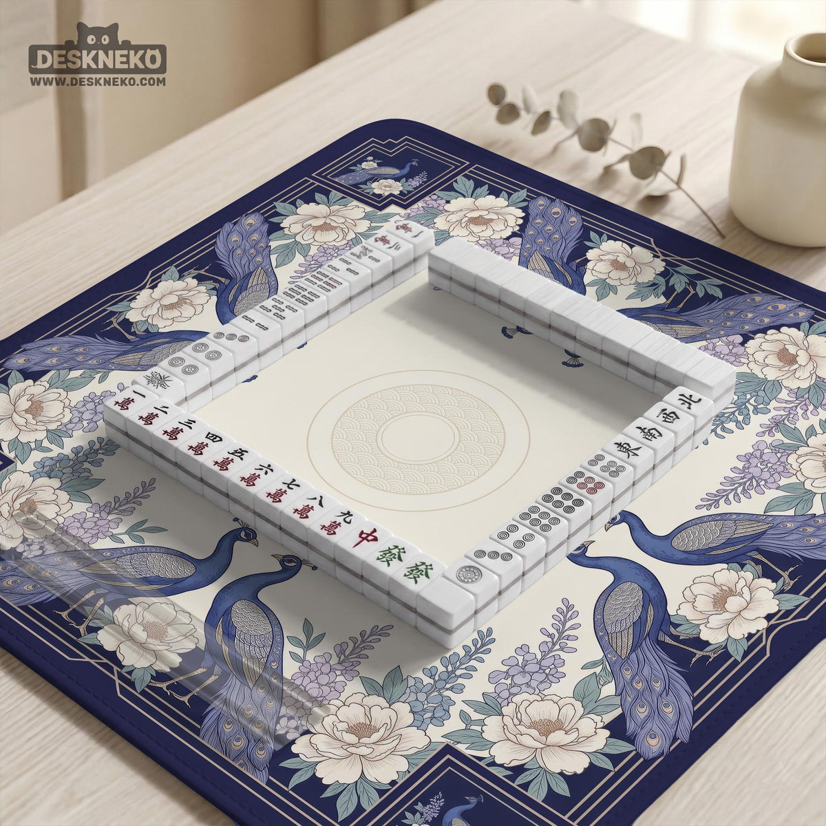 Blue mahjong mat with a floral peacock border and an open center area for tile play.