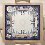 Blue mahjong table mat with a peacock and floral border, ivory center, lavender flowers, and scalloped edges.