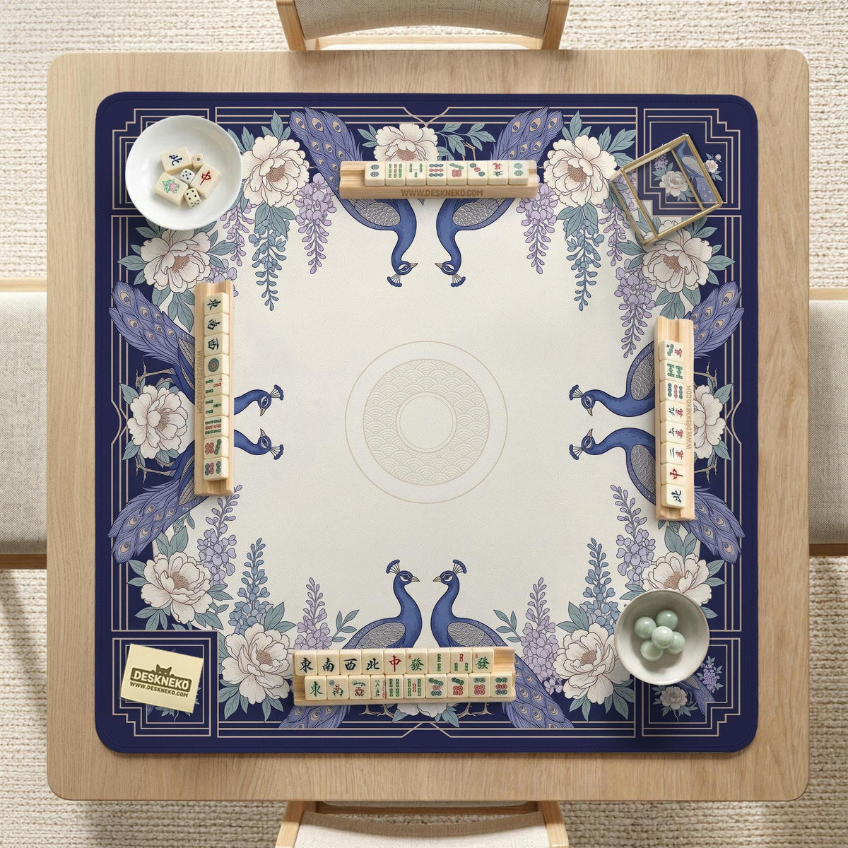 Blue mahjong mat with a floral peacock border and an open center area for tile play.