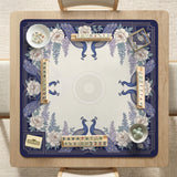 Blue mahjong mat with a floral peacock border and an open center area for tile play.