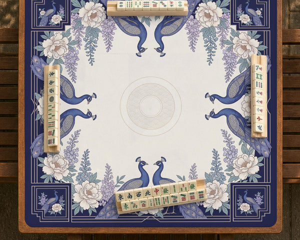 Blue mahjong mat with a floral peacock border and an open center area for tile play.
