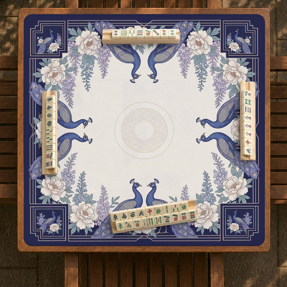 Blue mahjong mat with a floral peacock border and an open center area for tile play.