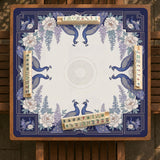 Blue mahjong mat with a floral peacock border and an open center area for tile play.