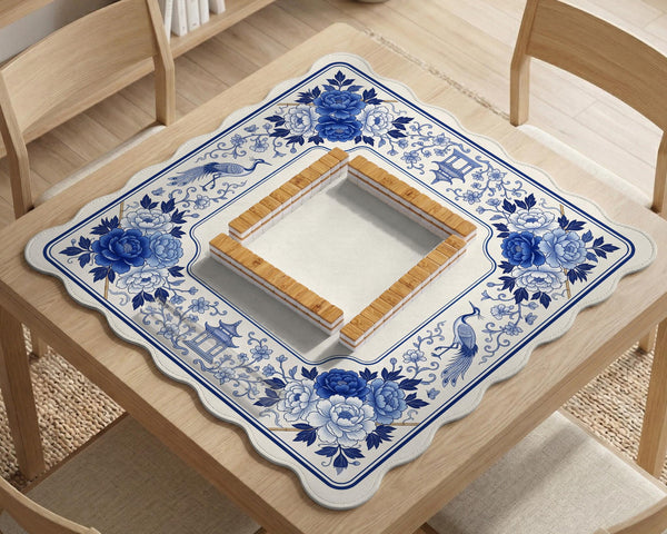 Square blue and white mahjong mat with peonies, cranes, pagoda accents, and chinoiserie linework around a plain center.