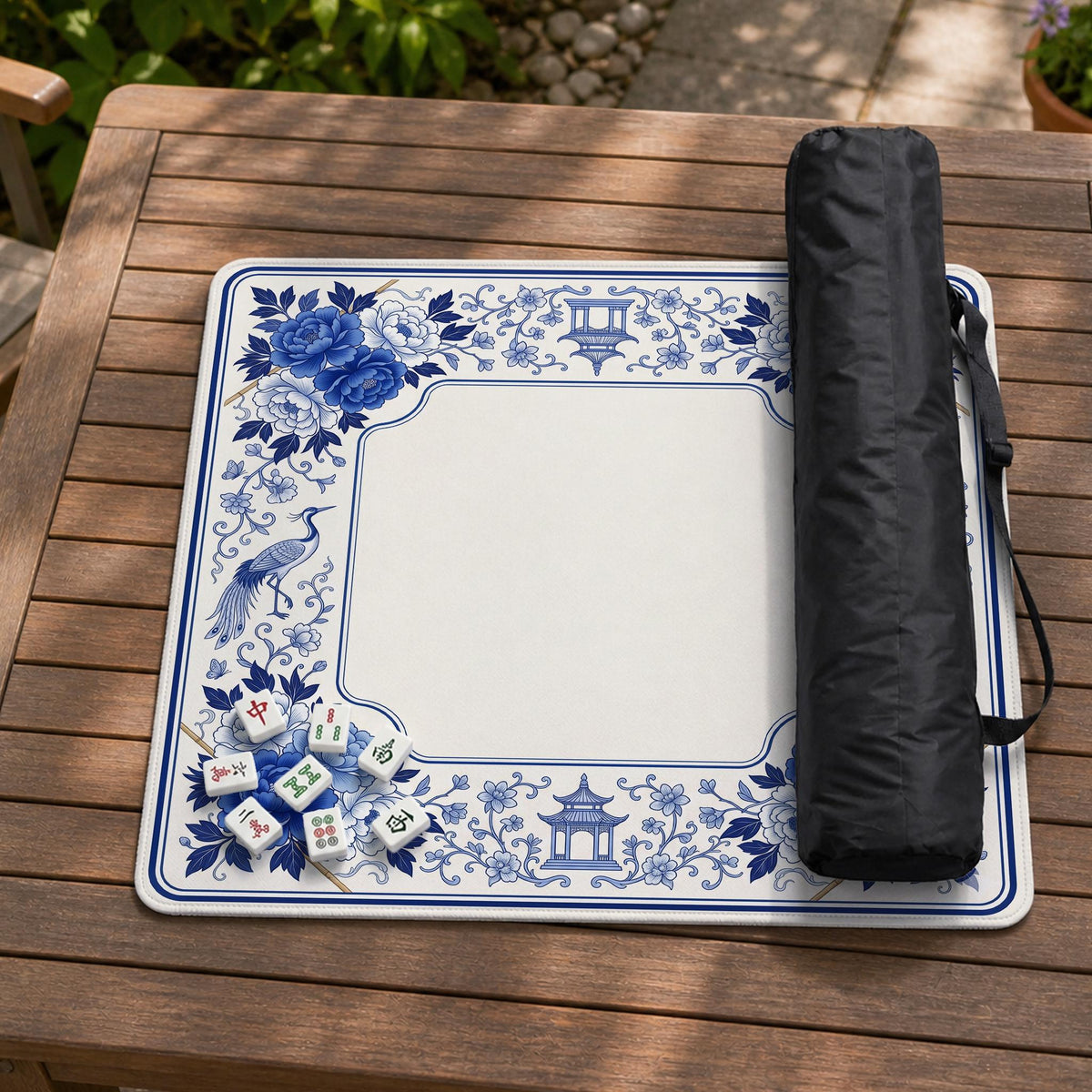 Square blue and white mahjong mat with peonies, cranes, pagoda accents, and chinoiserie linework around a plain center.