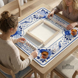 Square blue and white mahjong mat with peonies, cranes, pagoda accents, and chinoiserie linework around a plain center.