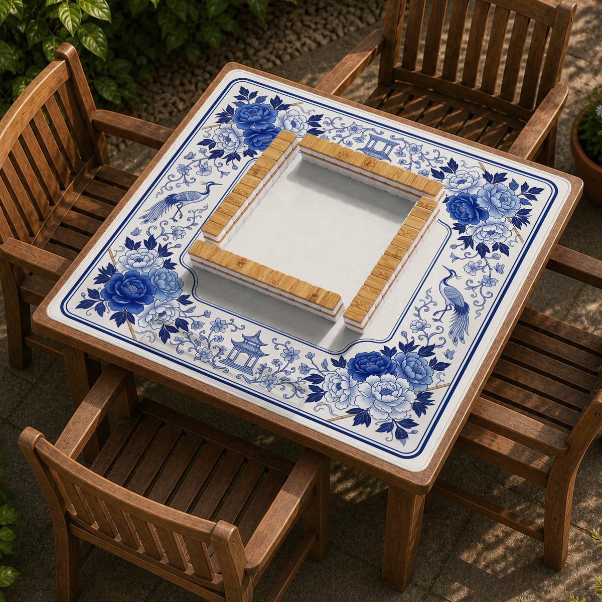Square blue and white mahjong mat with peonies, cranes, pagoda accents, and chinoiserie linework around a plain center.