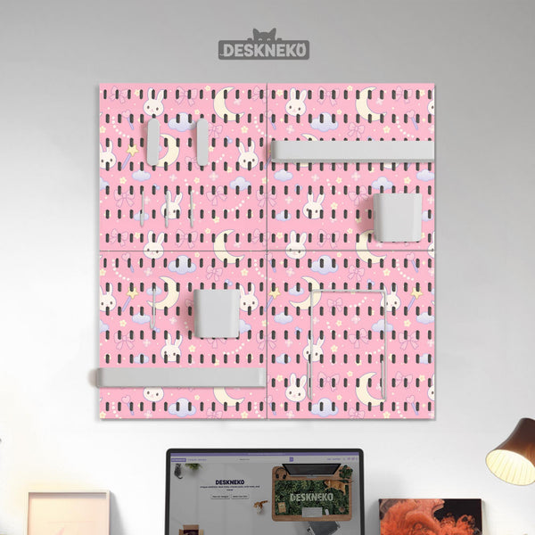 Pink pegboard panels with a kawaii bunny, cloud, moon, bow, and star pattern shown as a wall organizer set.