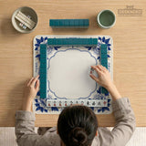 Blue and white mahjong mat with cranes, floral porcelain-style artwork, a cream center area, and a decorative border.