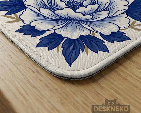 Blue and white mahjong mat with cranes, floral porcelain-style artwork, a cream center area, and a decorative border.