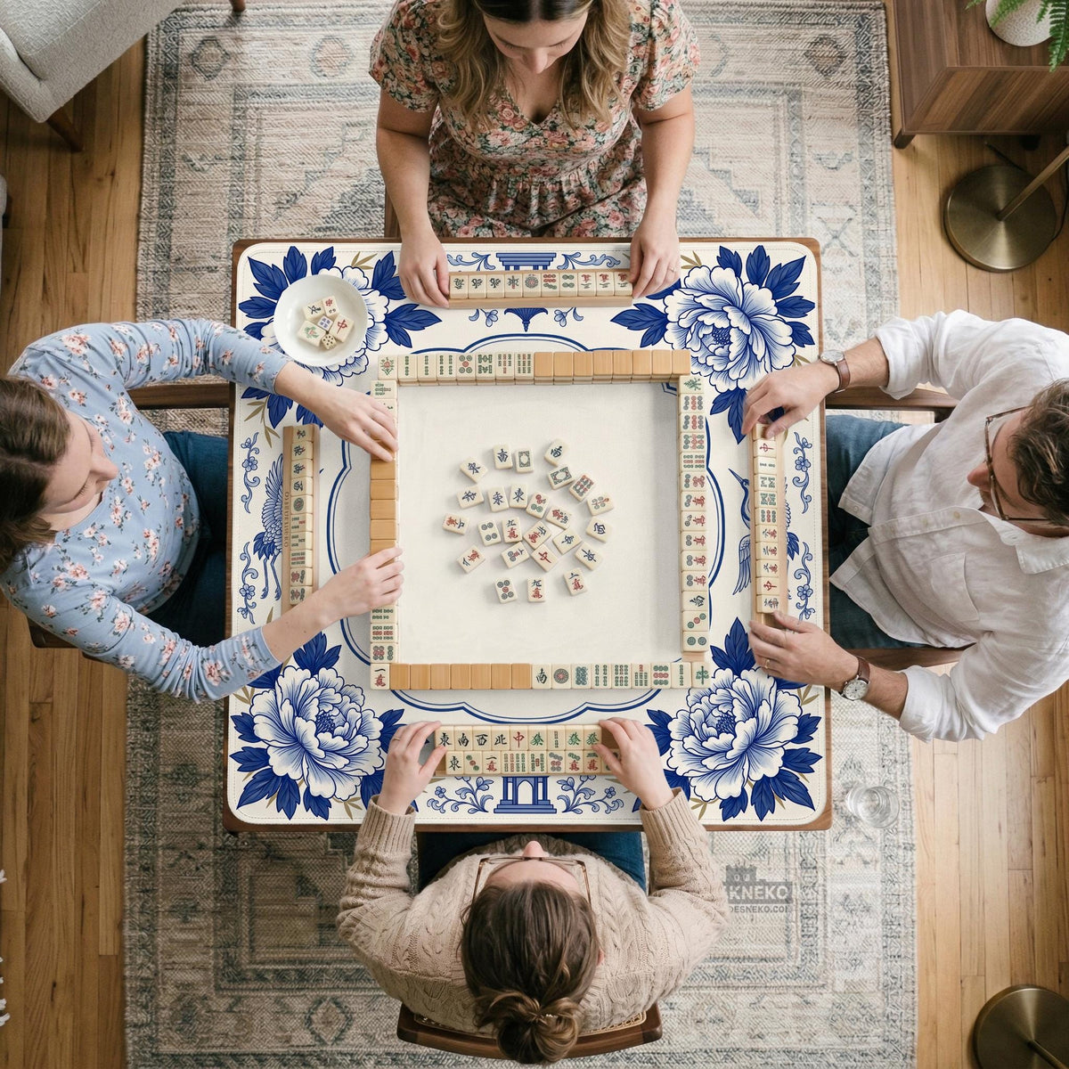Blue and white mahjong mat with cranes, floral porcelain-style artwork, a cream center area, and a decorative border.