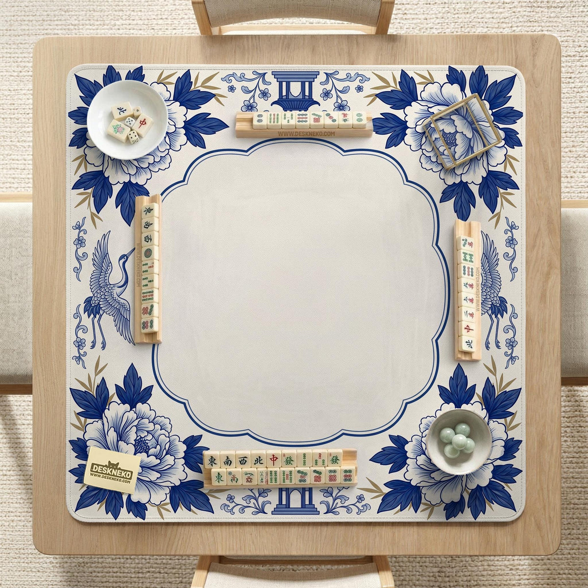 Blue and white mahjong mat with cranes, floral porcelain-style artwork, a cream center area, and a decorative border.