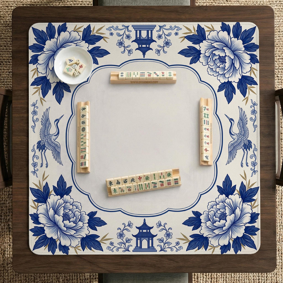 Blue and white mahjong mat with cranes, floral porcelain-style artwork, a cream center area, and a decorative border.