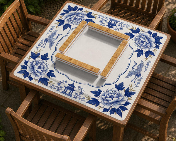 Blue and white mahjong mat with cranes, floral porcelain-style artwork, a cream center area, and a decorative border.