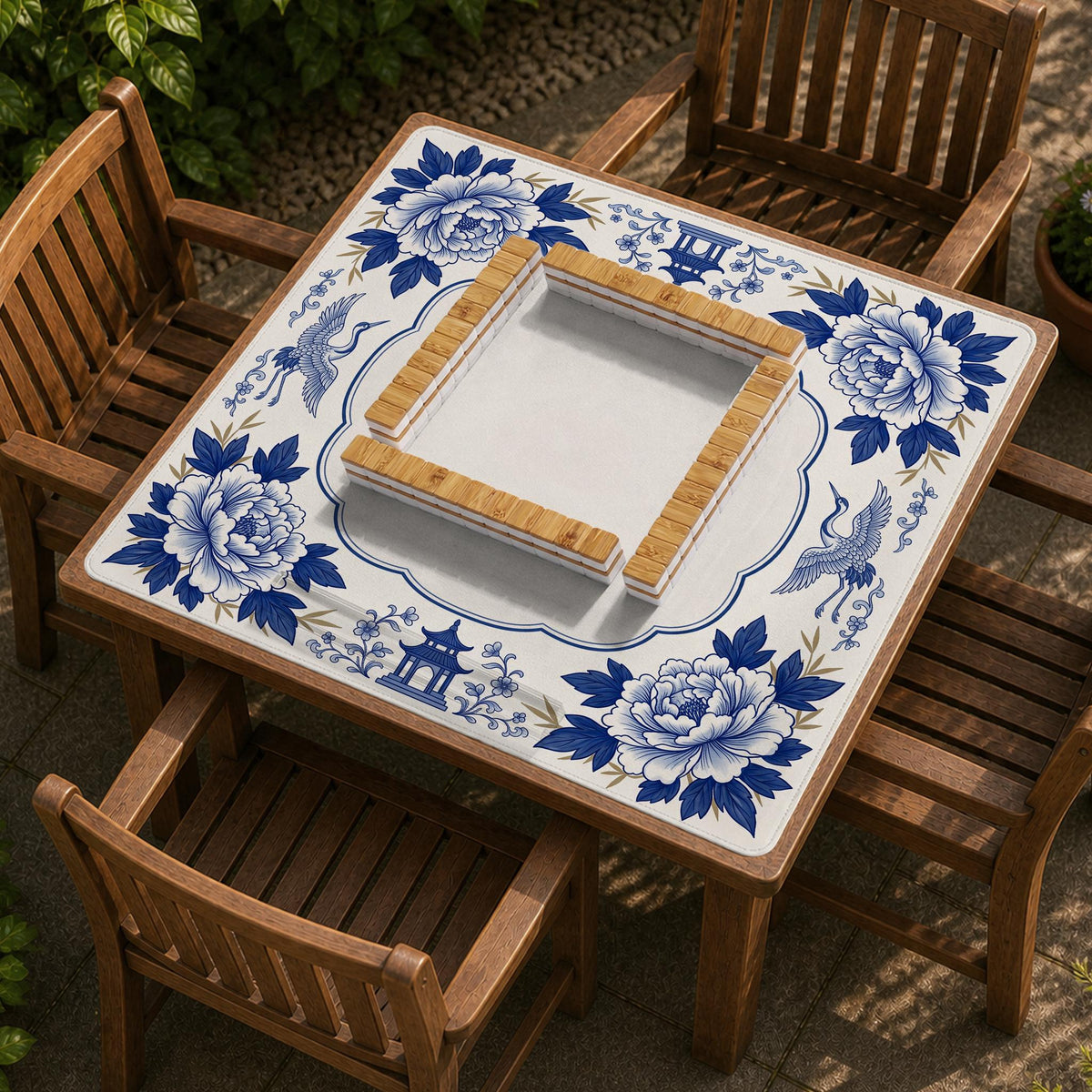 Blue and white mahjong mat with cranes, floral porcelain-style artwork, a cream center area, and a decorative border.