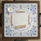 Square mahjong mat with a blue chinoiserie floral pattern on a light background.