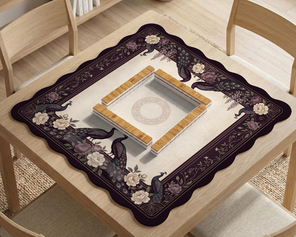 Square mahjong mat with a dark plum border, ivory floral pattern, muted sage leaves, and a decorative peacock garden design.