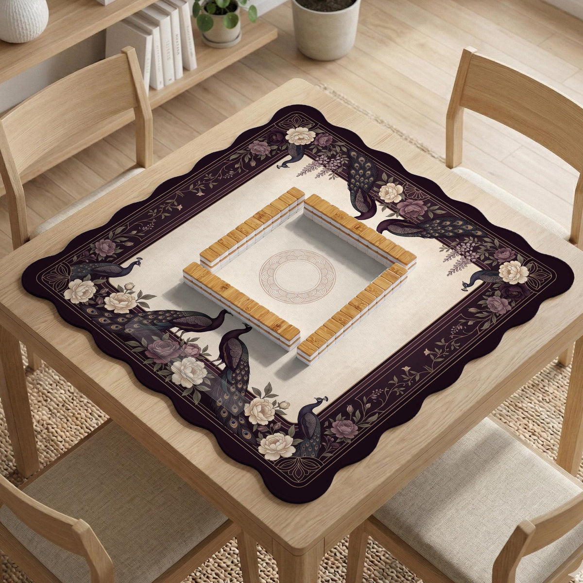 Square mahjong mat with a dark plum border, ivory floral pattern, muted sage leaves, and a decorative peacock garden design.