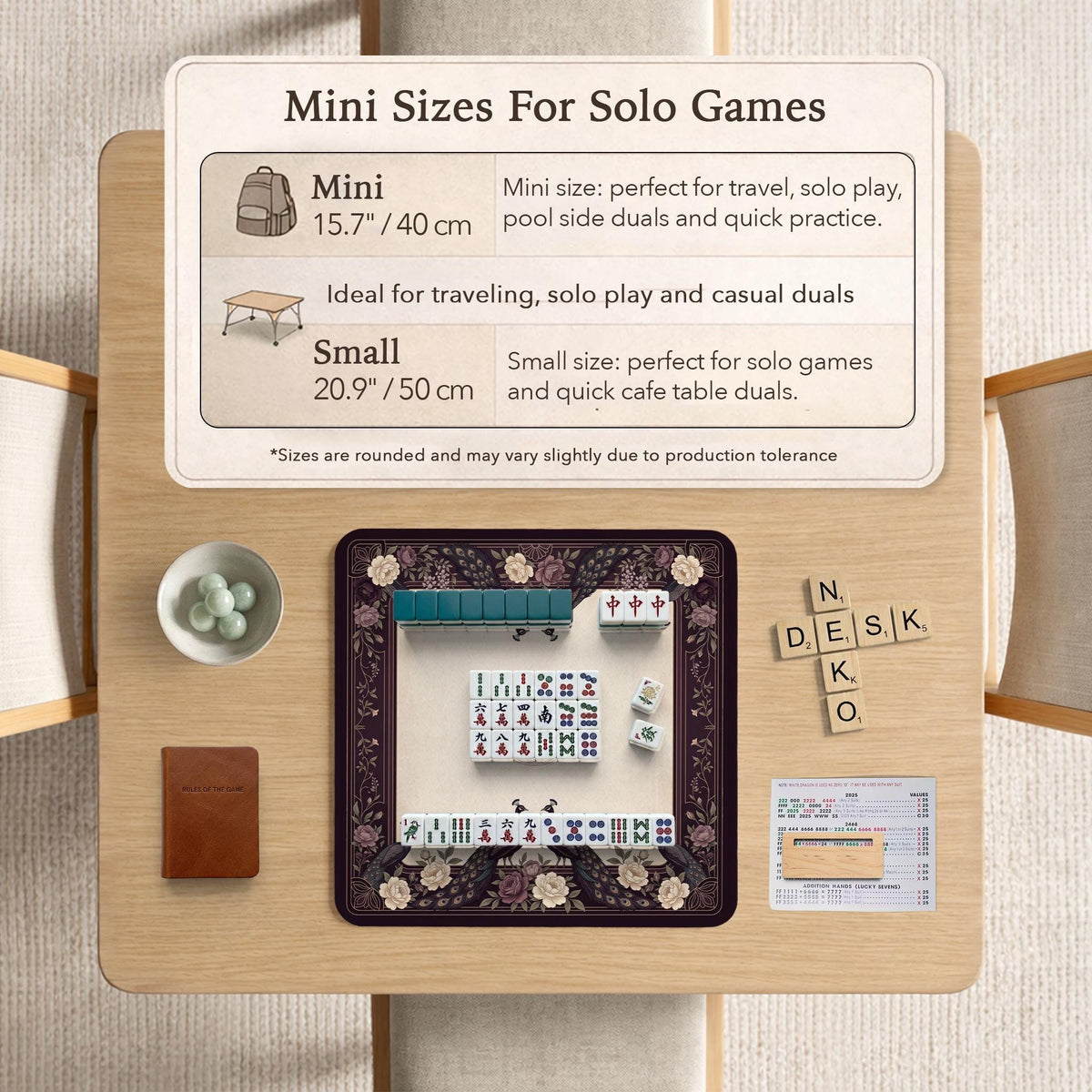 Square mahjong mat with a dark plum border, ivory floral pattern, muted sage leaves, and a decorative peacock garden design.