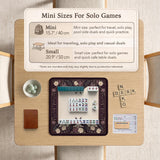 Square mahjong mat with a dark plum border, ivory floral pattern, muted sage leaves, and a decorative peacock garden design.