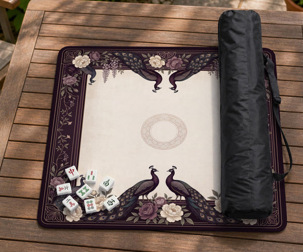 Square mahjong mat with a dark plum border, ivory floral pattern, muted sage leaves, and a decorative peacock garden design.