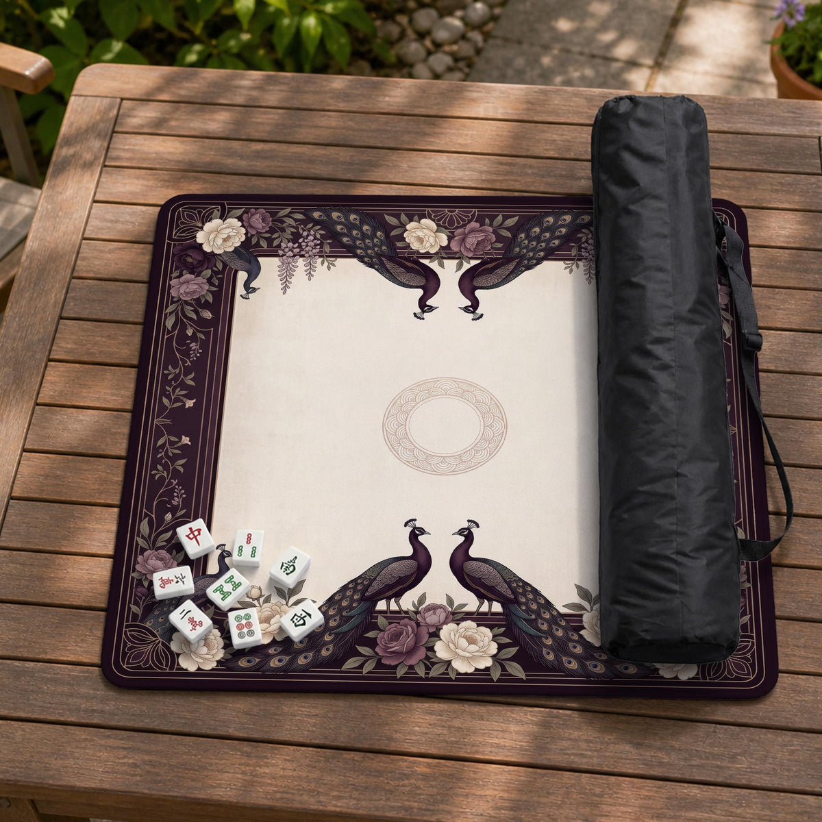 Square mahjong mat with a dark plum border, ivory floral pattern, muted sage leaves, and a decorative peacock garden design.