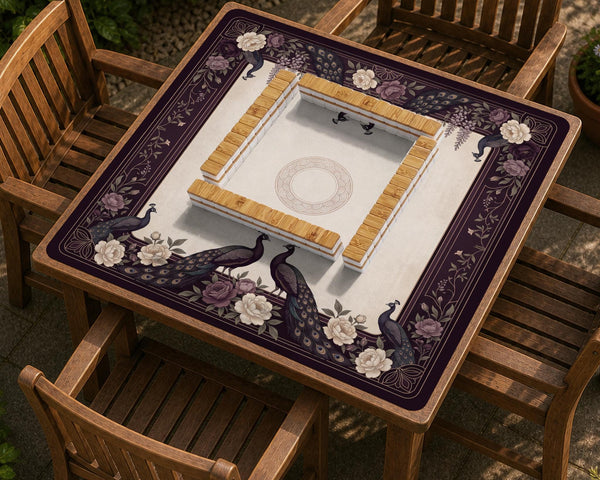 Square mahjong mat with a dark plum border, ivory floral pattern, muted sage leaves, and a decorative peacock garden design.