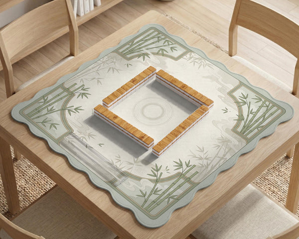 Square mahjong table mat with a pale cream center and green bamboo chinoiserie corners and border.