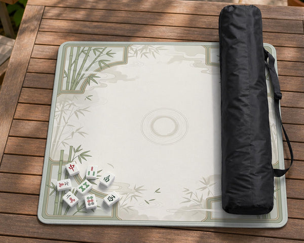 Square mahjong table mat with a pale cream center and green bamboo chinoiserie corners and border.