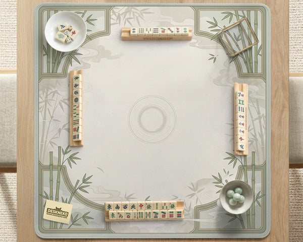 Square mahjong table mat with a pale cream center and green bamboo chinoiserie corners and border.