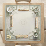 Square mahjong table mat with a pale cream center and green bamboo chinoiserie corners and border.
