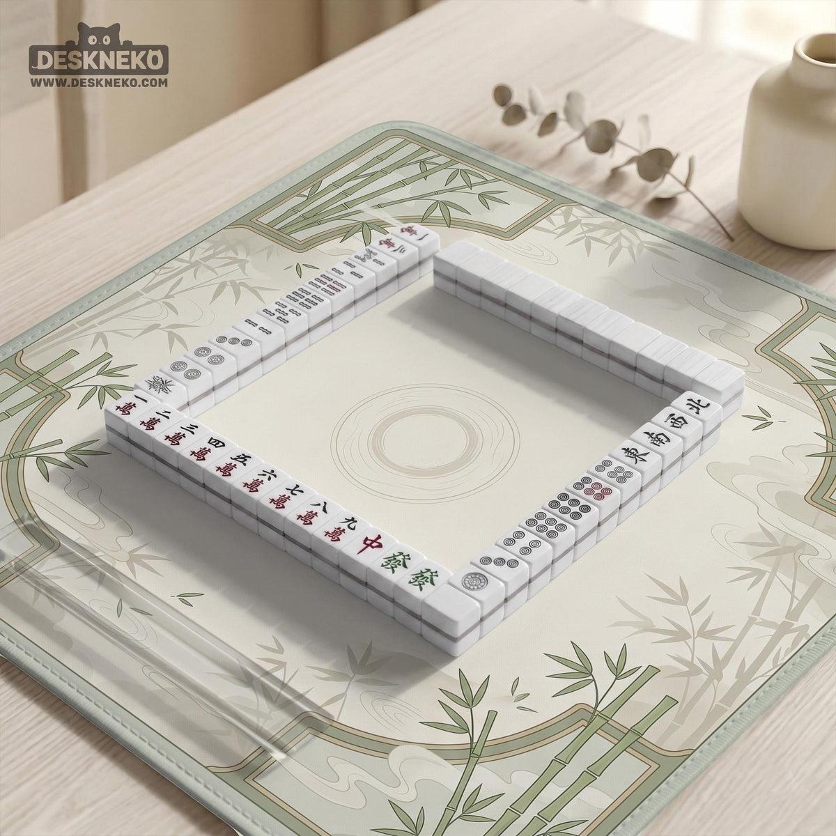 Square mahjong table mat with a pale cream center and green bamboo chinoiserie corners and border.