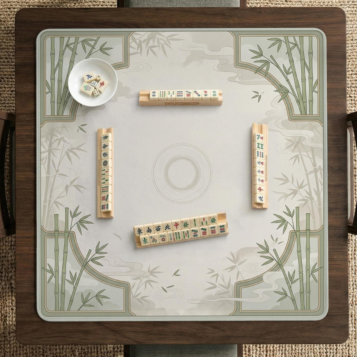 Square mahjong table mat with a pale cream center and green bamboo chinoiserie corners and border.