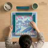 Pastel aqua mahjong table mat with peacock birds, pink flowers, pavilion details, and ornate floral linework.