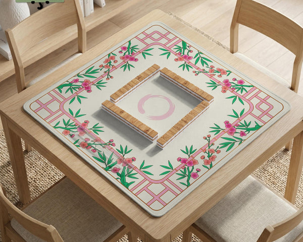 Pink cherry blossom floral mahjong table mat with a cream center and bamboo-style border design.