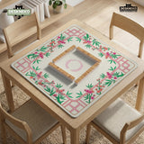 Pink cherry blossom floral mahjong table mat with a cream center and bamboo-style border design.