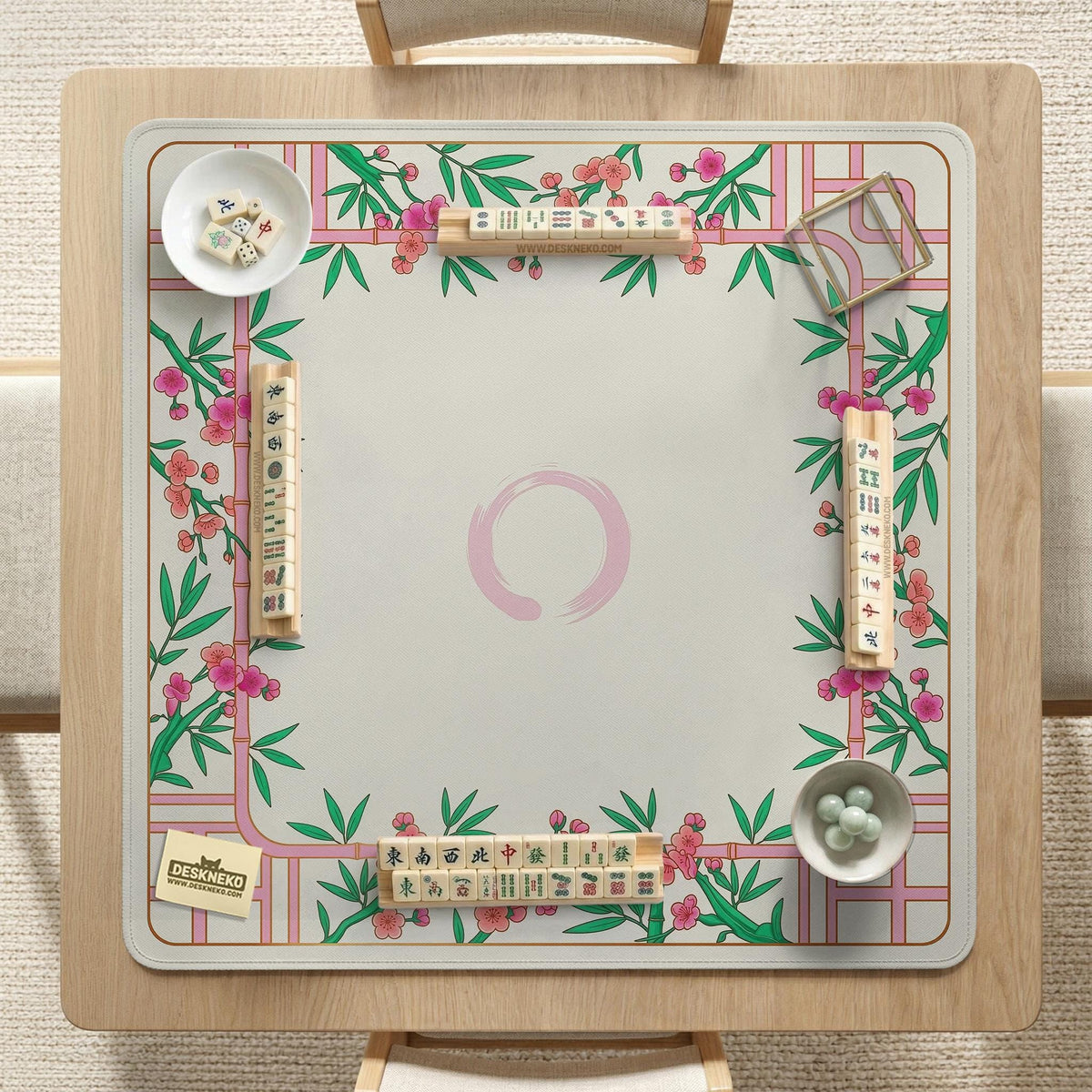 Pink cherry blossom floral mahjong table mat with a cream center and bamboo-style border design.