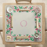 Pink cherry blossom floral mahjong table mat with a cream center and bamboo-style border design.