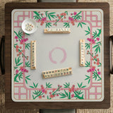 Pink cherry blossom floral mahjong table mat with a cream center and bamboo-style border design.