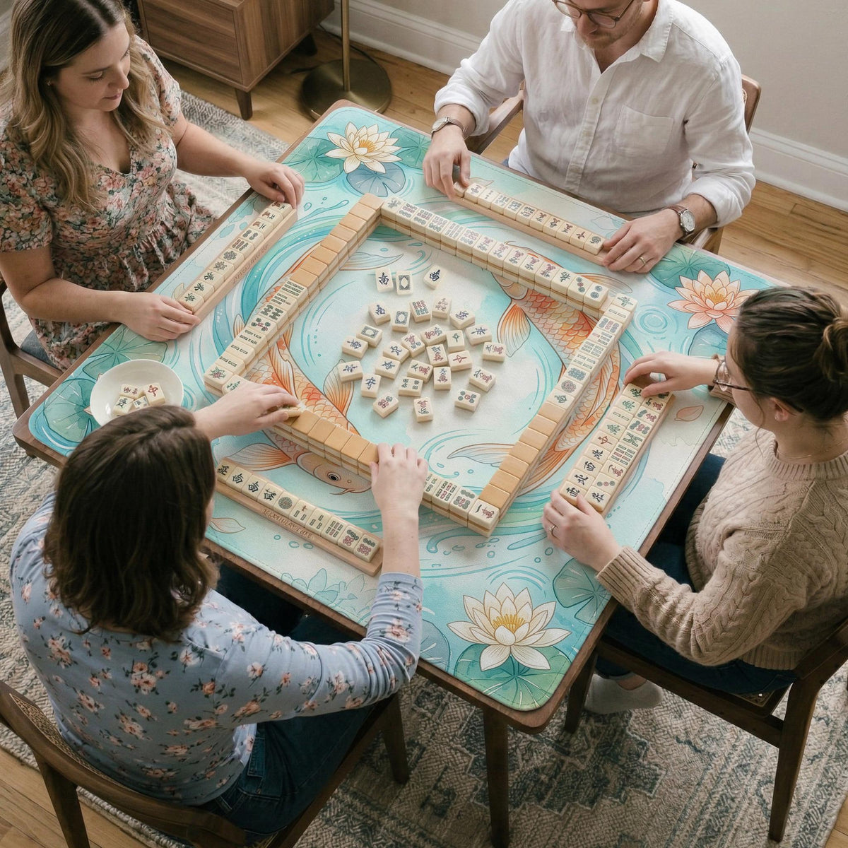 Pastel aqua square mahjong mat with orange koi fish, lotus flowers, lily pads, and flowing water lines.