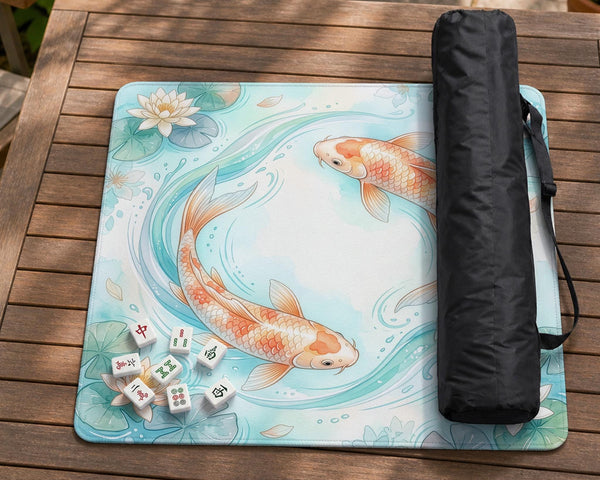 Pastel aqua square mahjong mat with orange koi fish, lotus flowers, lily pads, and flowing water lines.