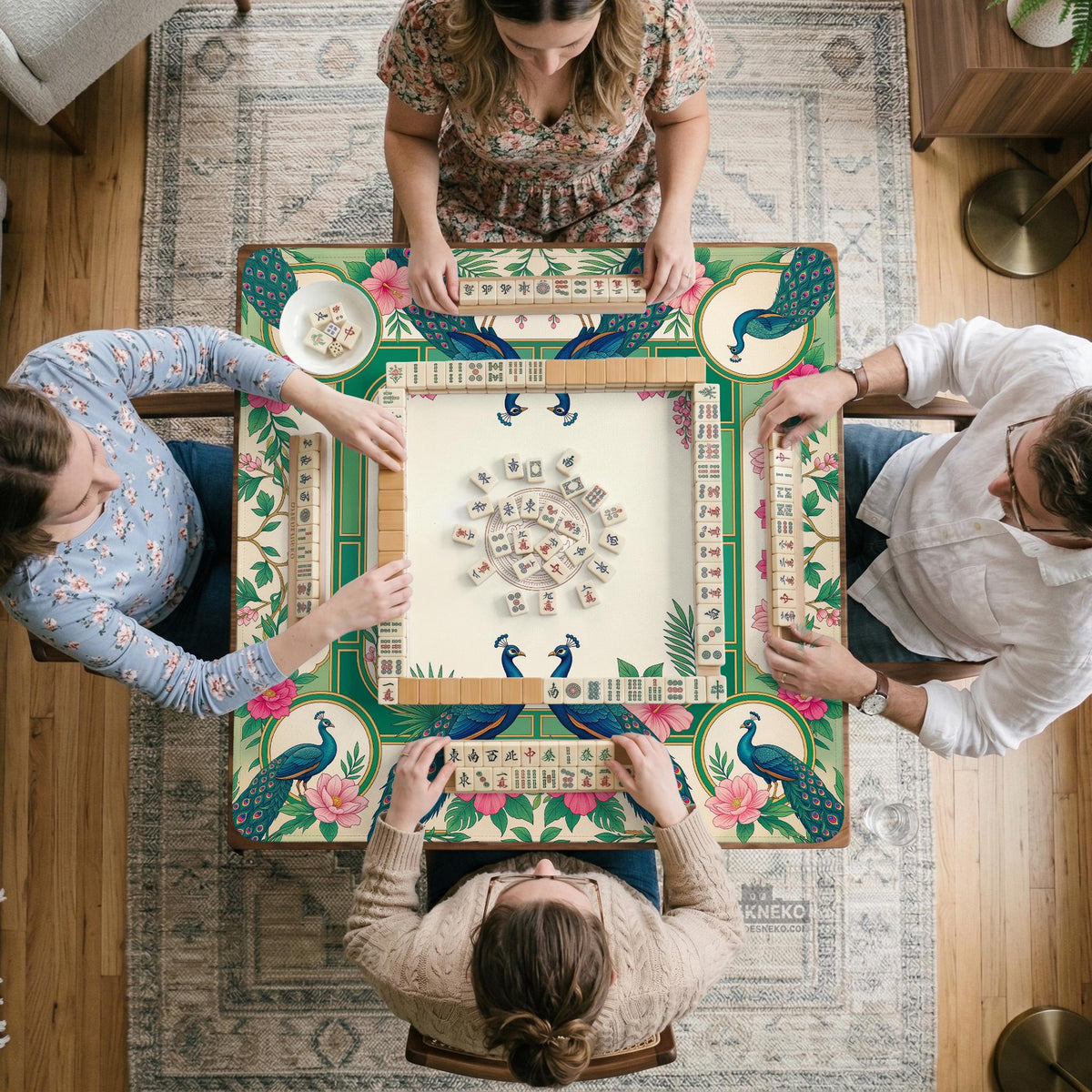 Green mahjong mat with peacocks, hibiscus flowers, tropical leaves, cream center space, and a scalloped floral border.
