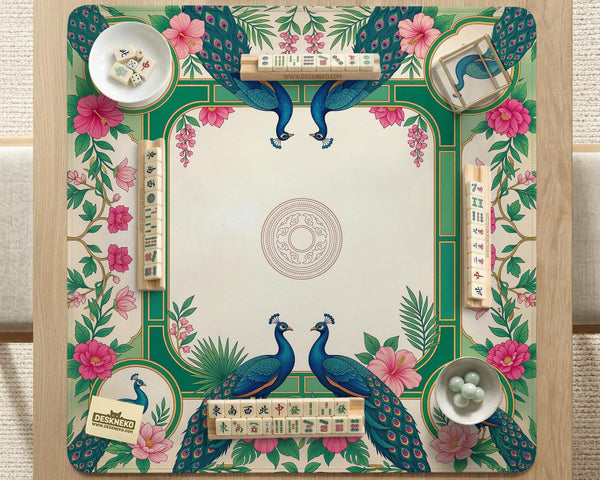 Green mahjong mat with peacocks, hibiscus flowers, tropical leaves, cream center space, and a scalloped floral border.