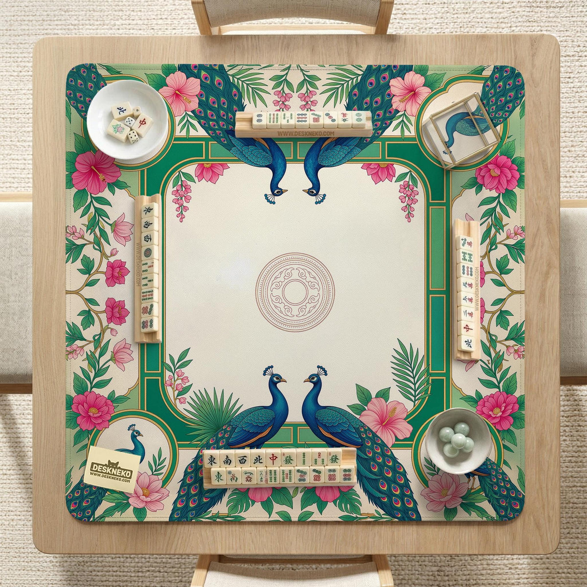 Green mahjong mat with peacocks, hibiscus flowers, tropical leaves, cream center space, and a scalloped floral border.