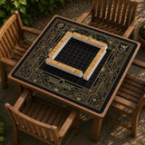 Black and gold square mahjong mat with a scalloped edge, geometric border, thin line details, fan motifs, and dragon and phoenix accents around an open center.