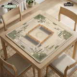 Square mahjong mat with a sage green bamboo and mountain design, cream center, scalloped border details, and gold line accents.