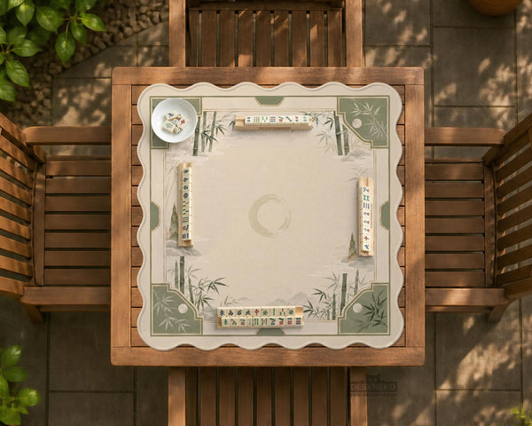 Square mahjong mat with a sage green bamboo and mountain design, cream center, scalloped border details, and gold line accents.