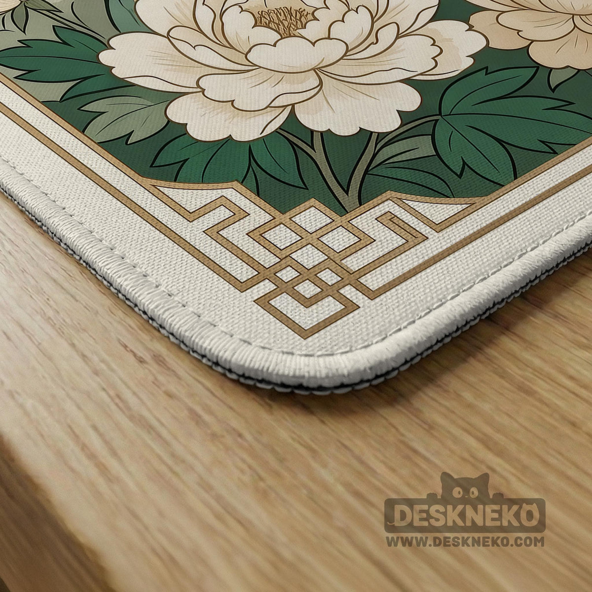 A green mahjong mat with peacock, floral, bamboo, pagoda, and gold border artwork in a scalloped chinoiserie style.
